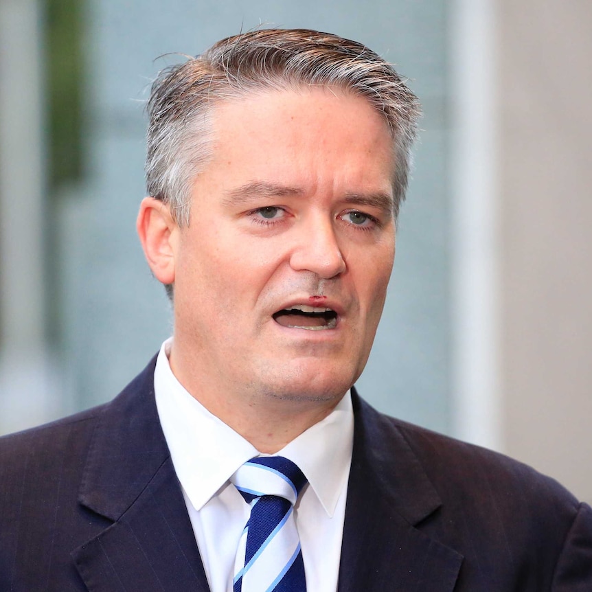 Finance Minister Mathias Cormann pauses while talking to the media outside Parliament House.