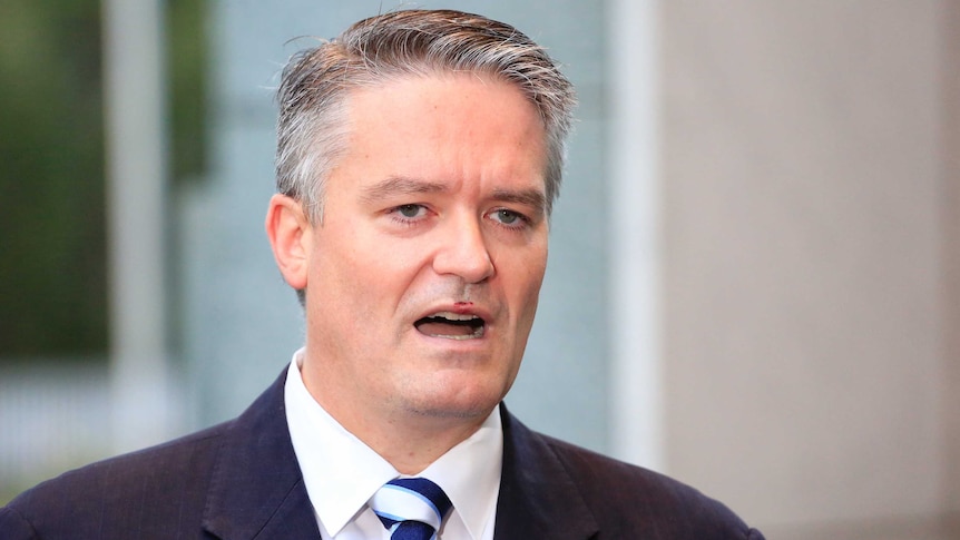 Finance Minister Mathias Cormann pauses while talking to the media outside Parliament House.