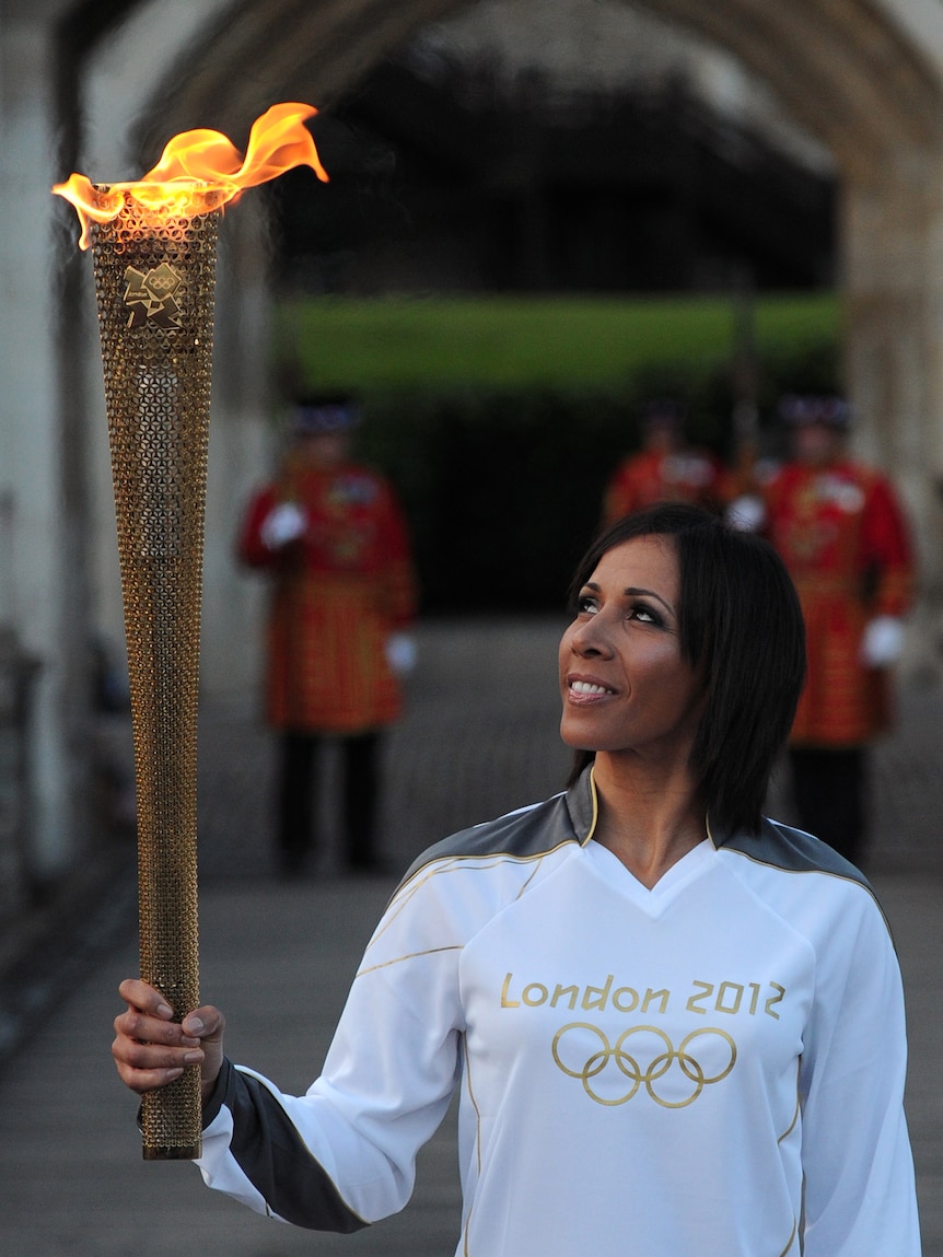 Britain's Dame Kelly Holmes brings the flame to the Tower of London.