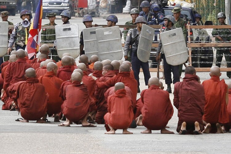 Monks sit infront of riot police in Burma