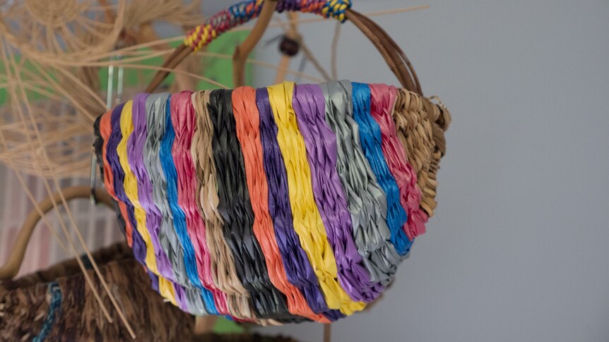 A basket made from sticks and old florist ribbons.
