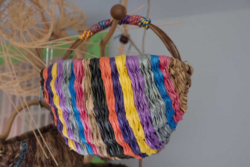 A basket made from sticks and old florist ribbons.