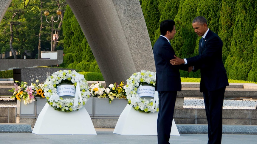 US President Obama shakes hands with Japanese PM Shinzo Abe after laying wreaths at the Hiroshima Peace Memorial Park.