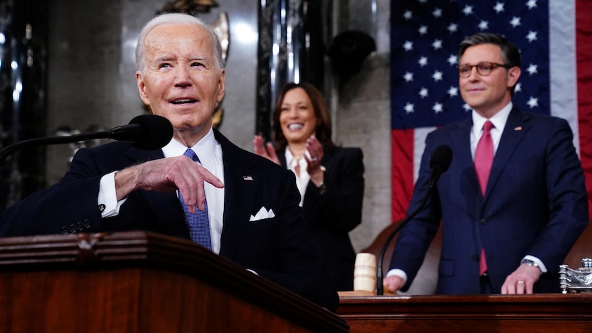 Joe Biden speaks into a microphone 
