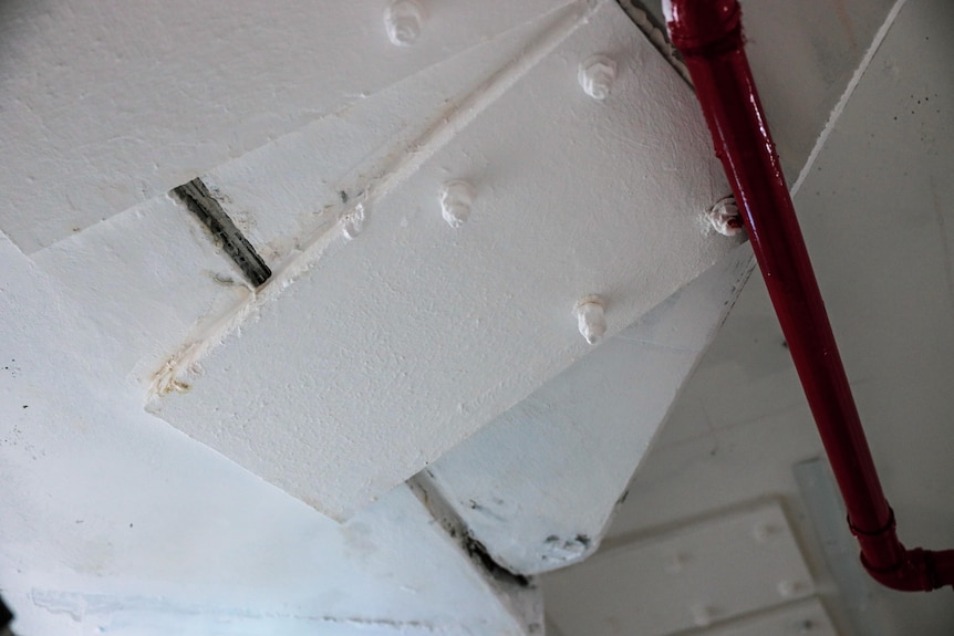 A concrete roof, with a metal plate bolted on to it.