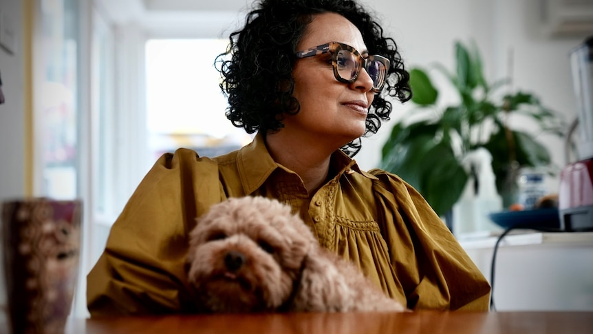 Sarah Ibrahim with her dog in her Sydney home in June 2022.