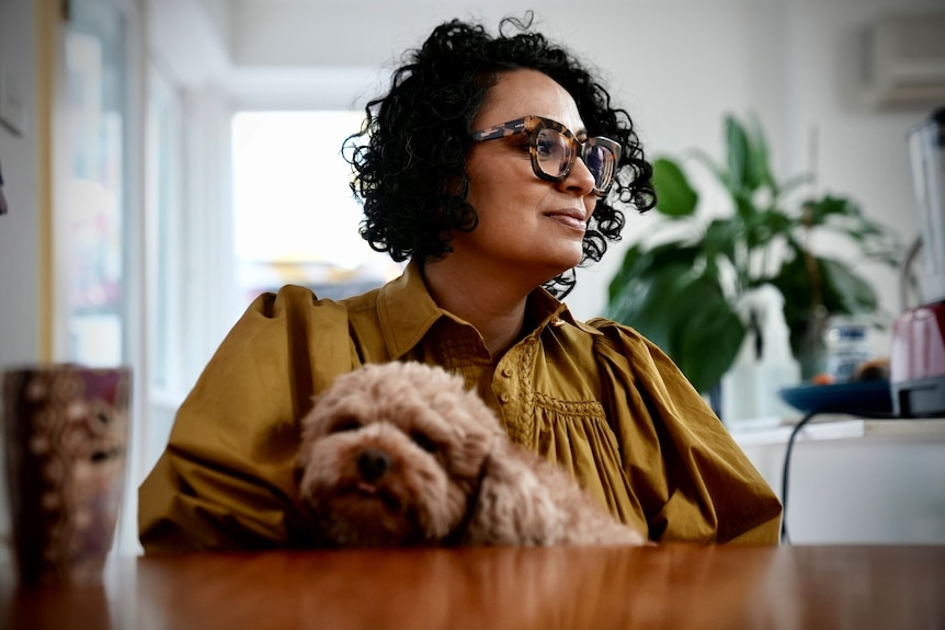 Sarah Ibrahim with her dog in her Sydney home in June 2022.