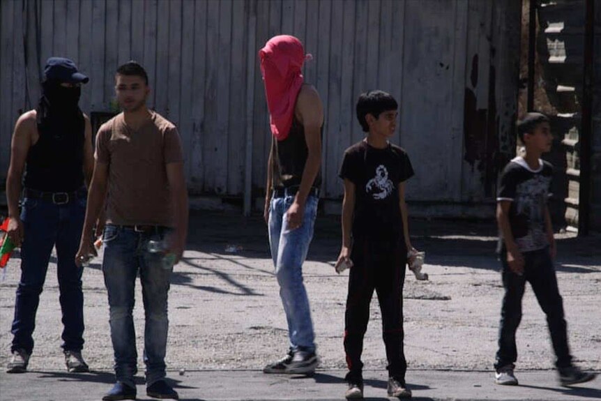 Boys hold rocks in West Bank