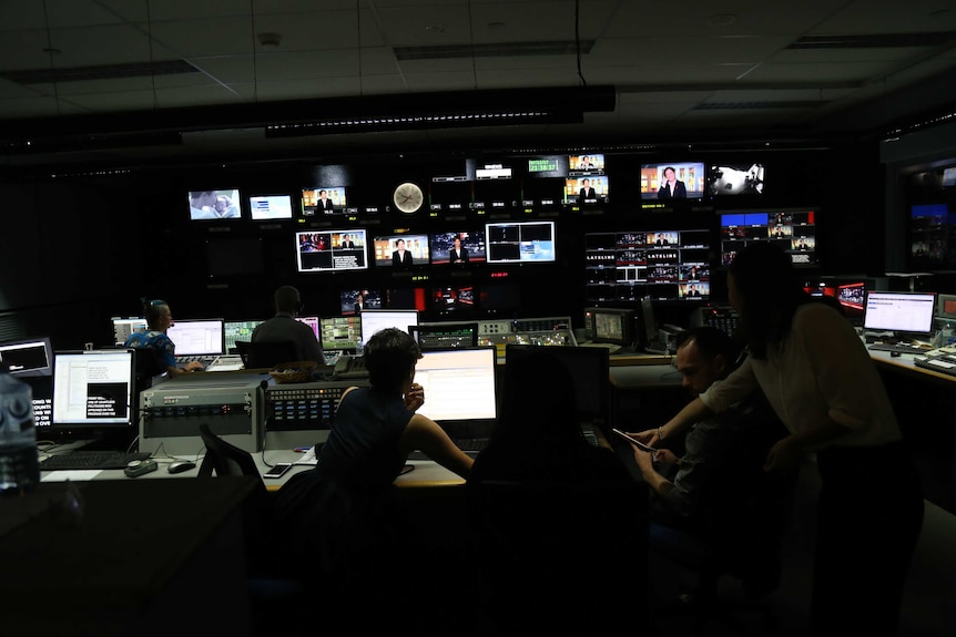 TV production staff in the studio control room.