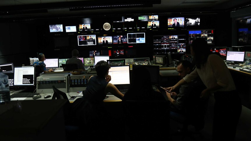 TV production staff in the studio control room.