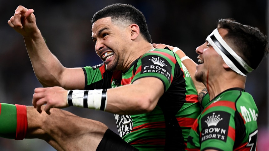 Two South Sydney NRL players celebrate a try against Cronulla.