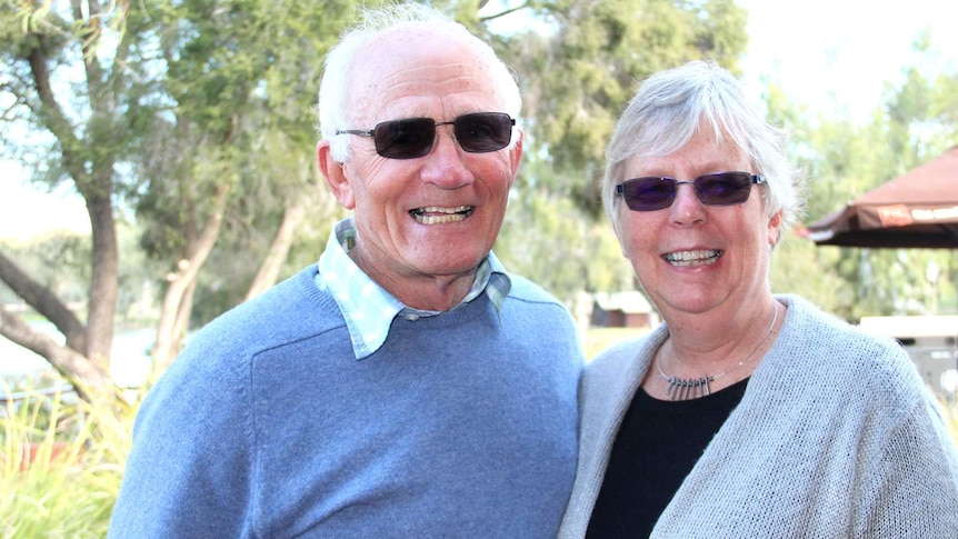 Man and woman Greg and Angela O'Brien -  both with tinted glasses looking at camera