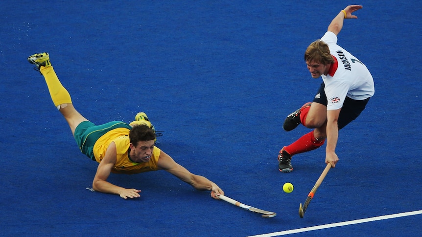 Maitland's Simon Orchard and Ashley Jackson of Great Britain challenge for the ball.