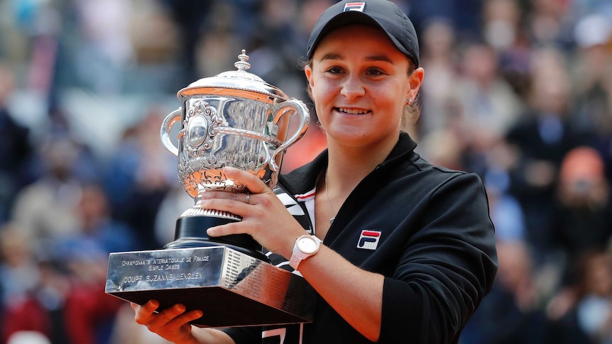 Ashleigh Barty holds the French Open trophy and smiles