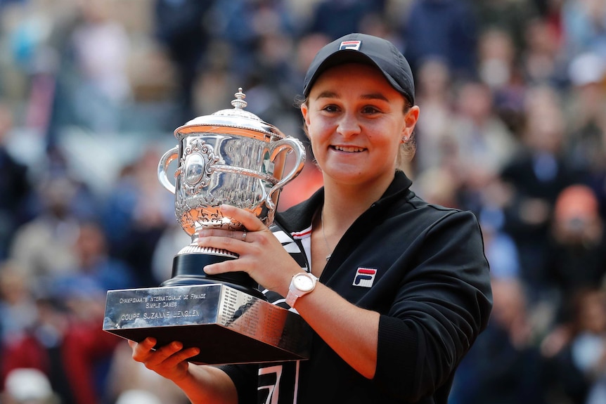 Ashleigh Barty holds the French Open trophy and smiles