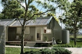 A design of a prefabricated house with solar panels on the roof and trees surrounding it.
