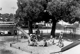 Children and adults in a playground at Diamantina Receiving Depot and Infants' Home around 1940