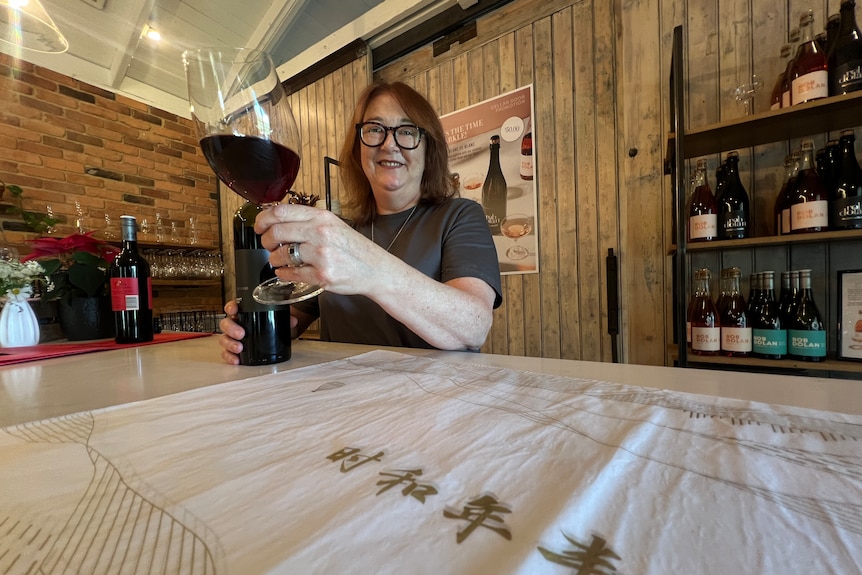 Winemaker Meg Brodtmann with a glass of red wine.