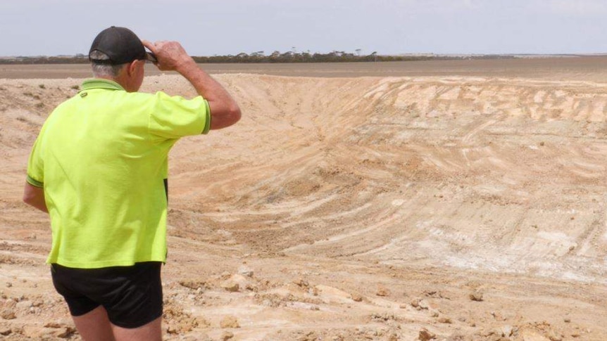 Mallee Hill farmer Noel Bairstow stands at the edge of an empty dam