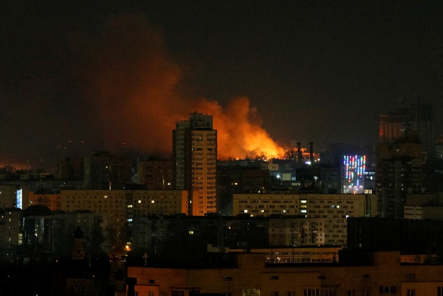 Smoke and flames in the distance of a long shot of a skyline near Kyiv.