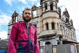 Greens Councillor Jonathan Sri standing in front of the burnt down Broadway Hotel, taken on 4th September, 2018