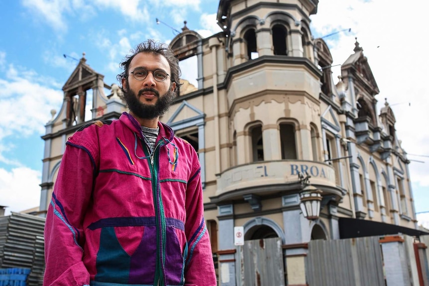 Greens Councillor Jonathan Sri standing in front of the burnt down Broadway Hotel at East Brisbane, on September 4, 2018.