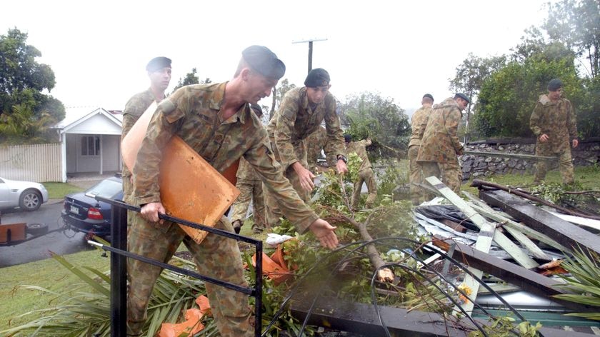 Soldiers from 6RAR based at Enoggera assist in the clean up