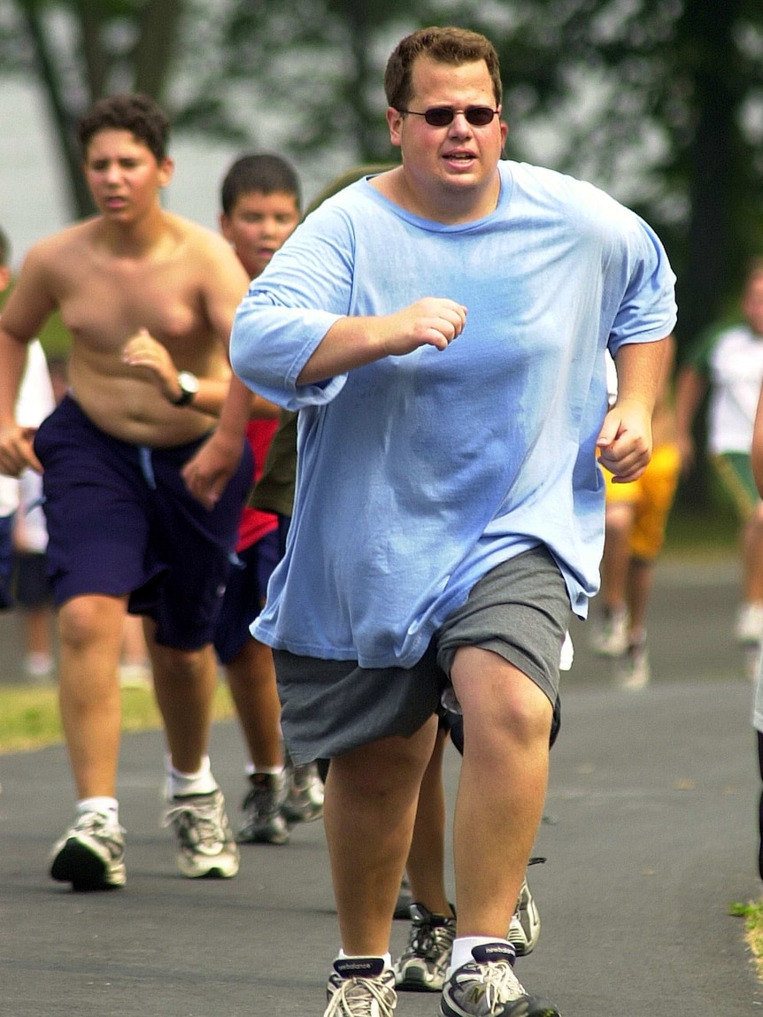 Participants run up a hill at a weight loss camp in the US