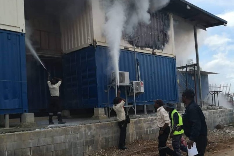 Authorities on Manus Island in Papua New Guinea extinguish a fire after an Indian asylum seeker self-immolated.