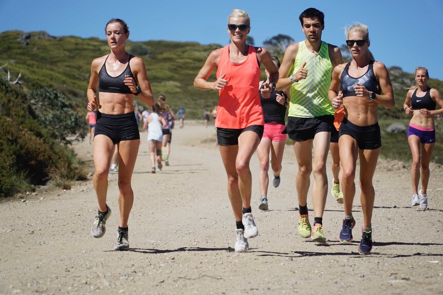 Eloise Wellings joins a group of athletes running on trails at Falls Creek in Victoria.
