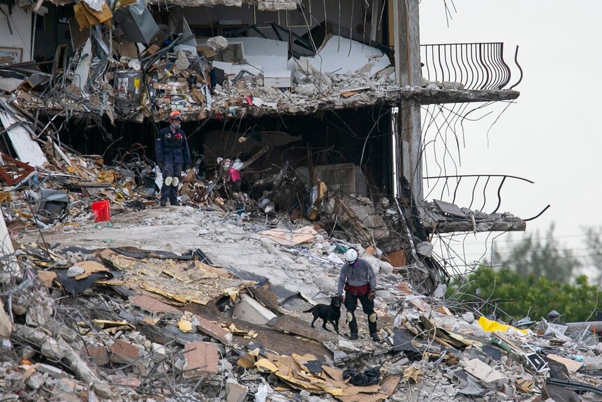 Search and rescue team look through rubble of collapsed Miami condo. 
