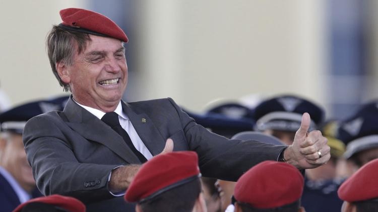 Brazilian politician Jair Bolsonaro in a red berest with young cadets