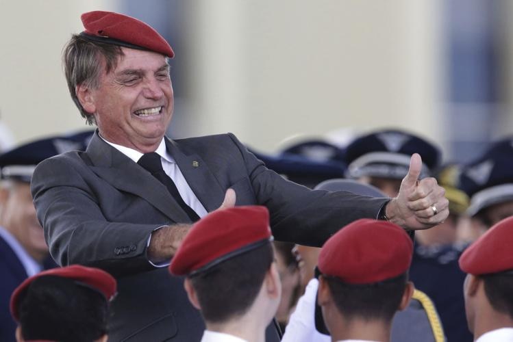 Brazilian politician Jair Bolsonaro in a red berest with young cadets