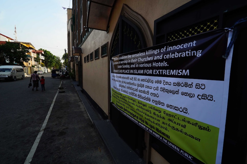 A large banner reads: 'We condemn the senseless killings of innocent Christians at worship in their Churches'.