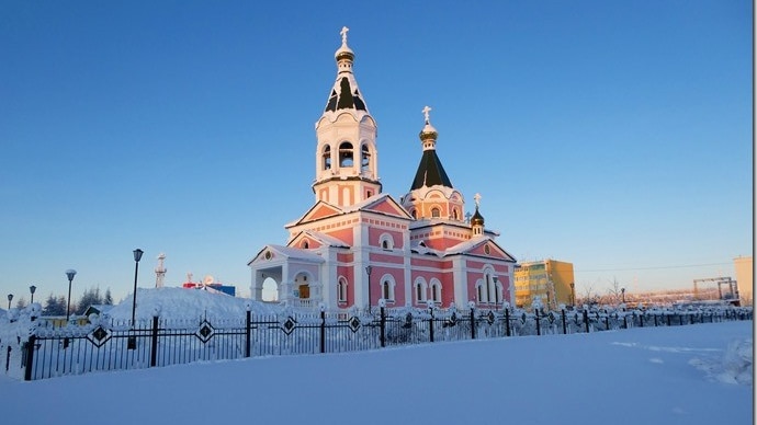 A white church, with high spires, in a snowy landscape