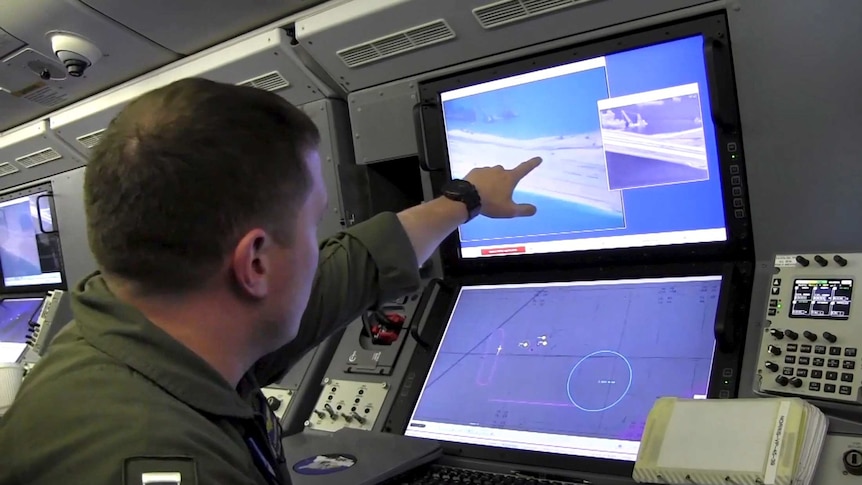 A US Navy crewman aboard a surveillance aircraft surveying the Spratly Islands