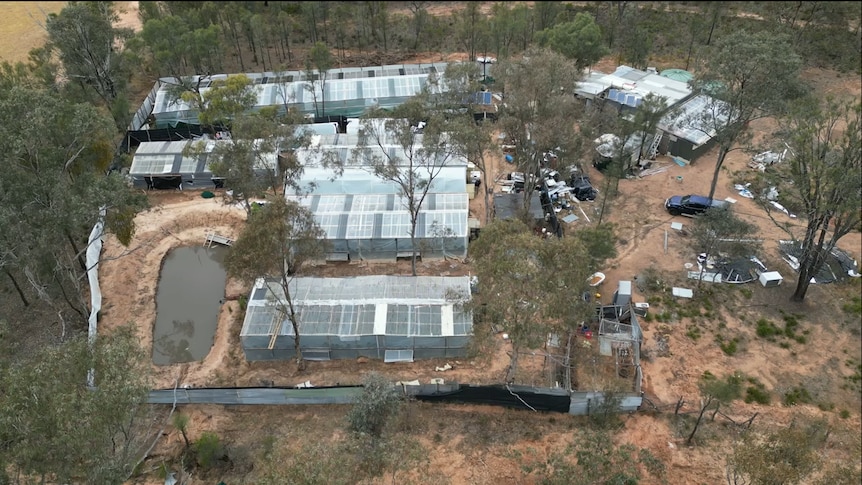 An aerial view of a property including greenhouses