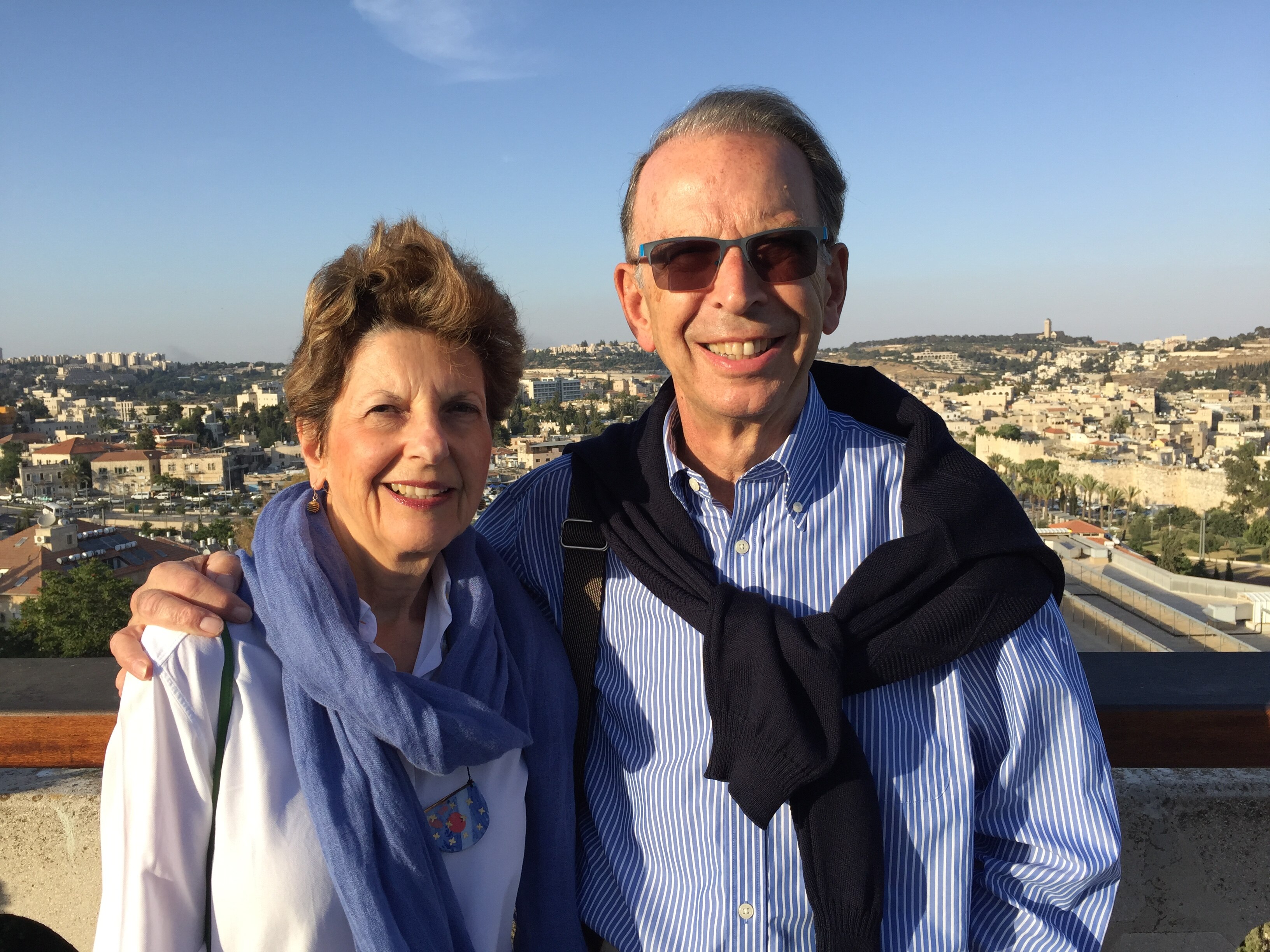 Jeff with arm around Violet Loewenstein facing camera with view behind them in Westbank