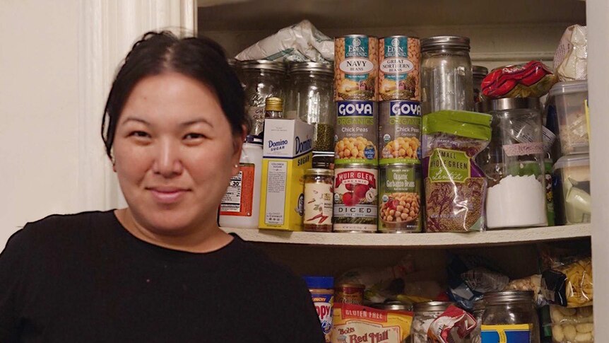 Food writer Hetty McKinnon in front of her home pantry stocked with tinned beans, lentils and flour, for coronavirus cooking.