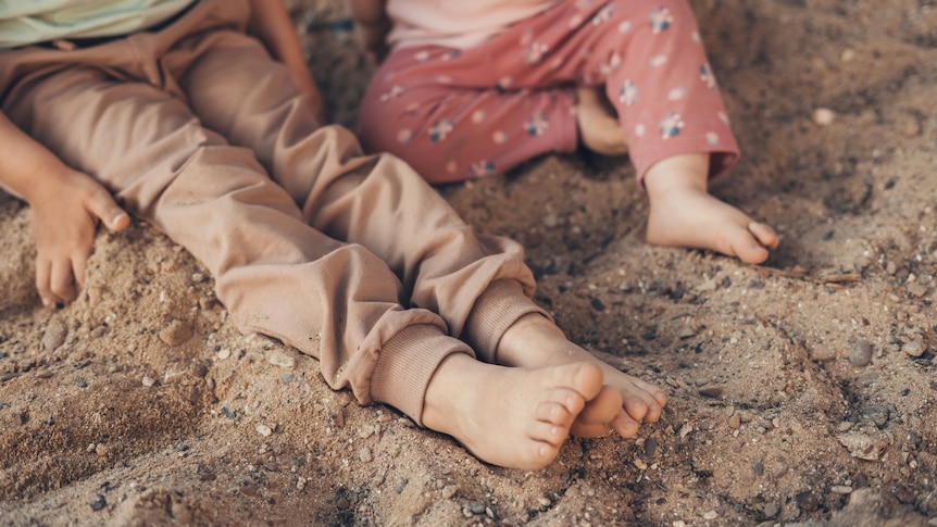 children's feet in the sand