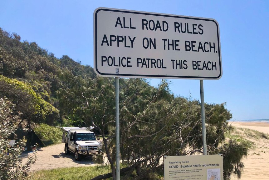 Road rules sign on sandy beach
