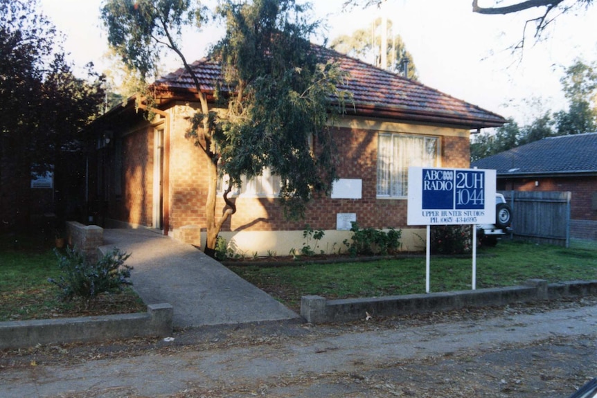 Exterior of the ABC bureau in a brick building with ABC sign out front.