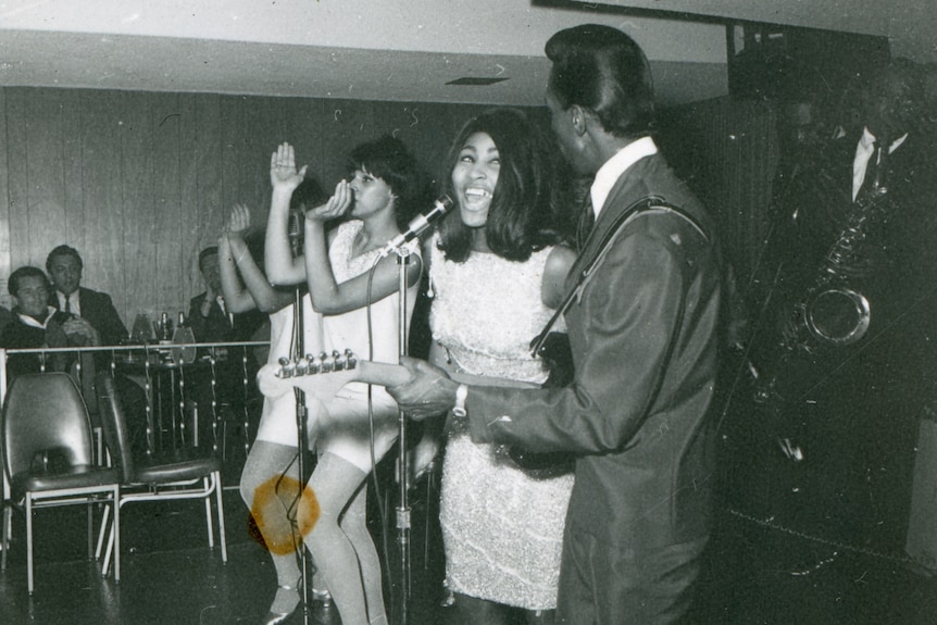 Black and white photo of Tina Turner and Ike Turner performing in 1965