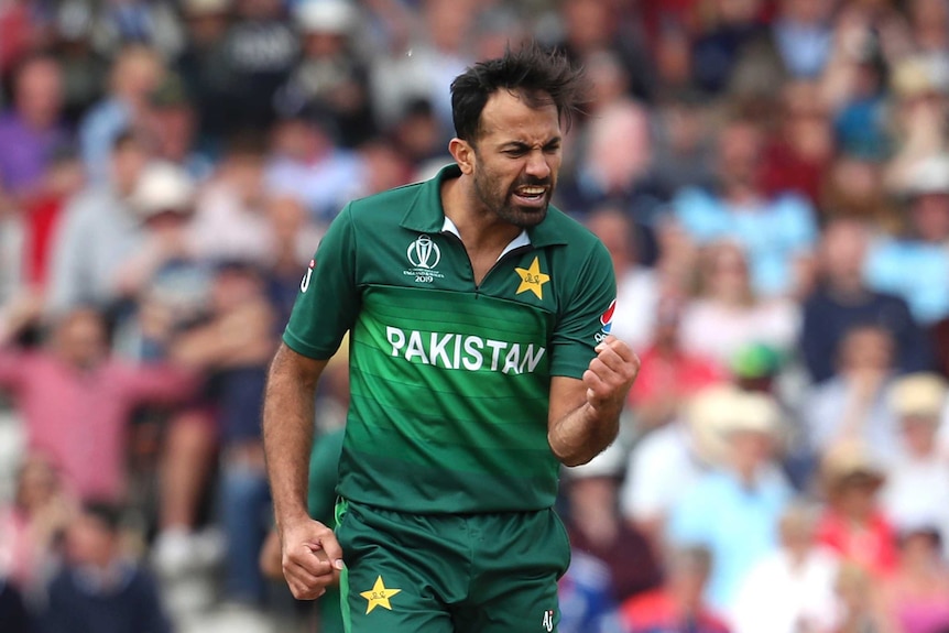 Wahab Riaz clenches his fist and grimaces in joy