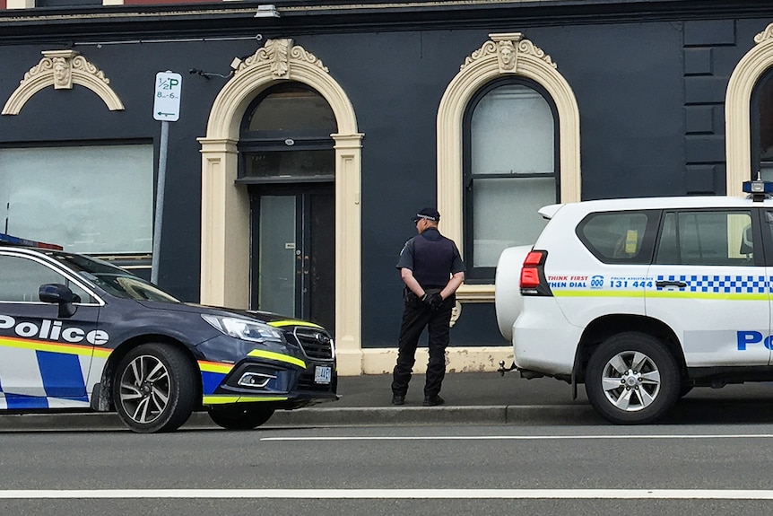 Uniformed police officer outside of Lloyds Hotel.