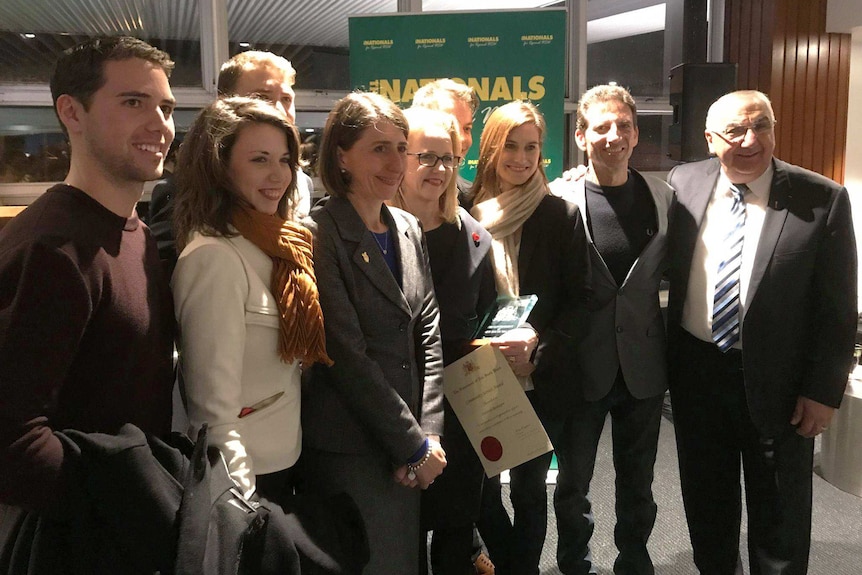 NSW Premier Gladys Berejklian with Serge and his family at an awards ceremony.