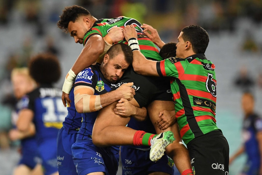 Josh Reynolds lifts Zane Musgrove in a tackle.