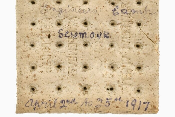 Square oat biscuit with the words Engineers Camp, Seymour, April 2nd to 25th 1917 written on one side.