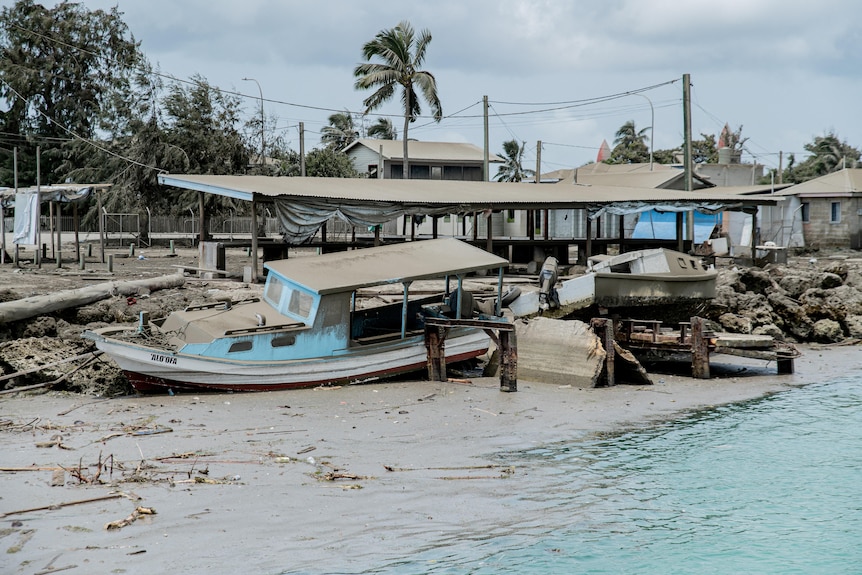 Markets on Tonga soon after volcanic eruption show buildings and boats covered in ash.