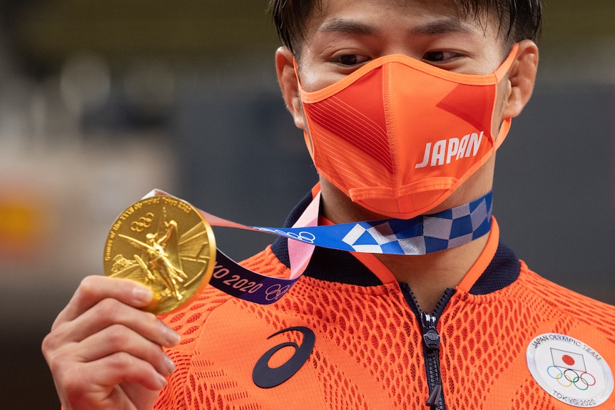 Japanese athlete with his Olympic gold medal
